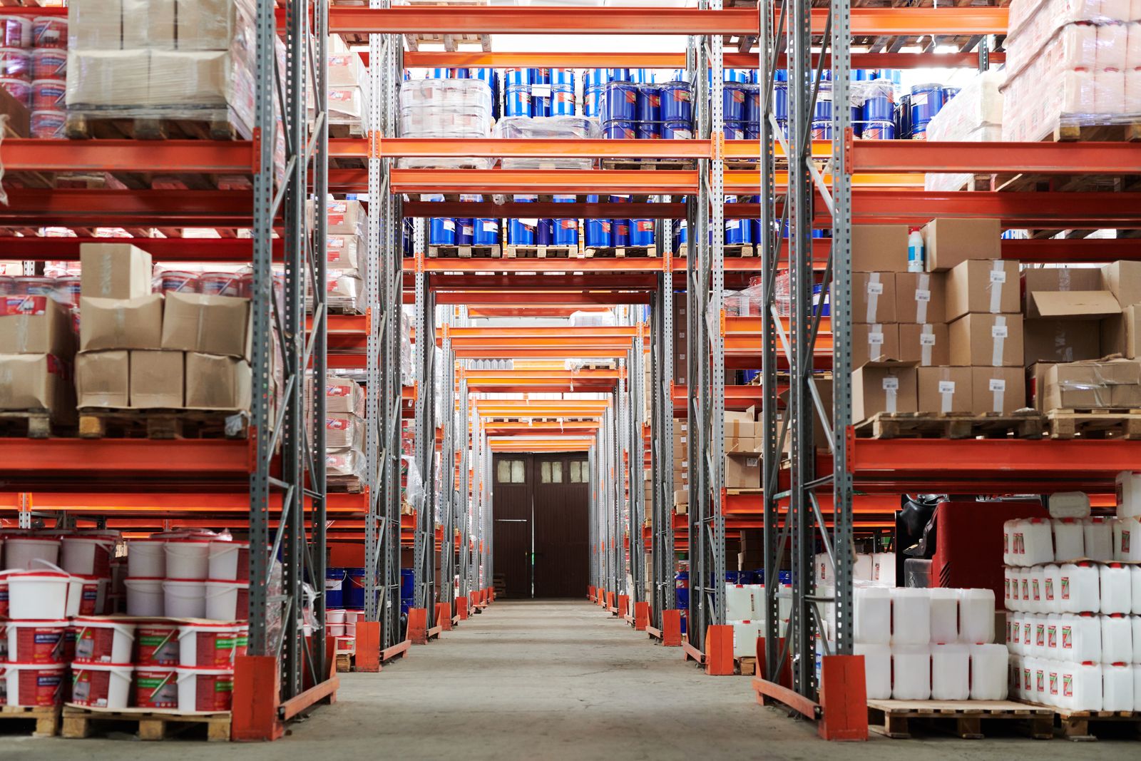 Autonomous mobile robot navigating a warehouse aisle with lidar and cameras